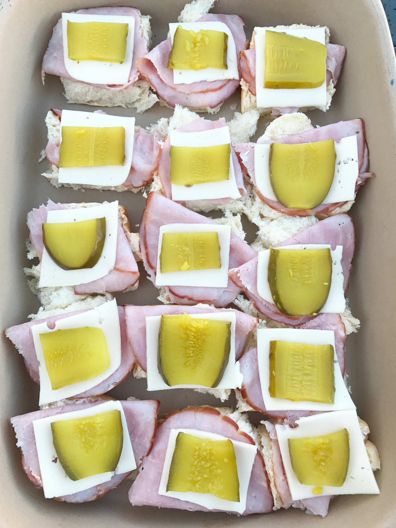 Cuban Sliders - These bite-sized sliders are filled with ham, swiss cheese and pickles on slider Hawaiian buns. 