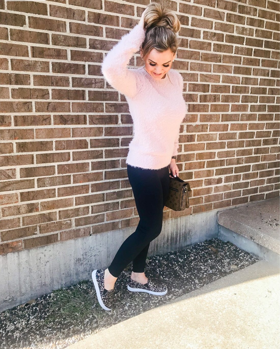 Fuzzy sweater with leggings and leopard slip-on shoes.