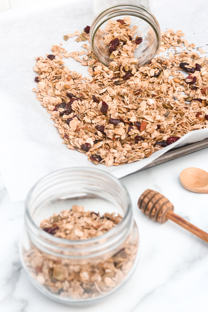 Easy Homemade Healthy Granola with a combination of oats, nuts, cranberries, vanilla, cinnamon, and maple syrup.